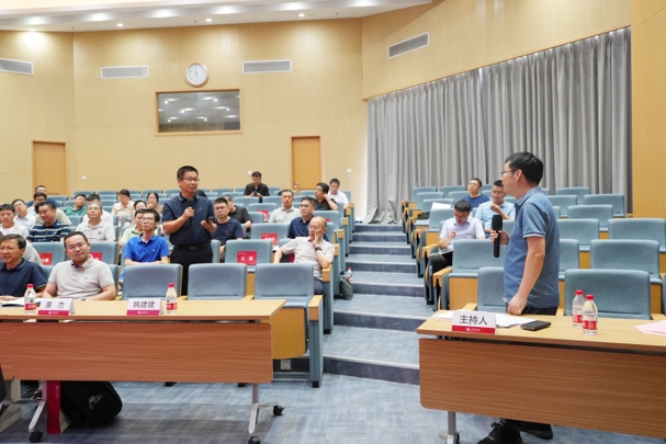 A person standing in front of a group of people

Description automatically generated