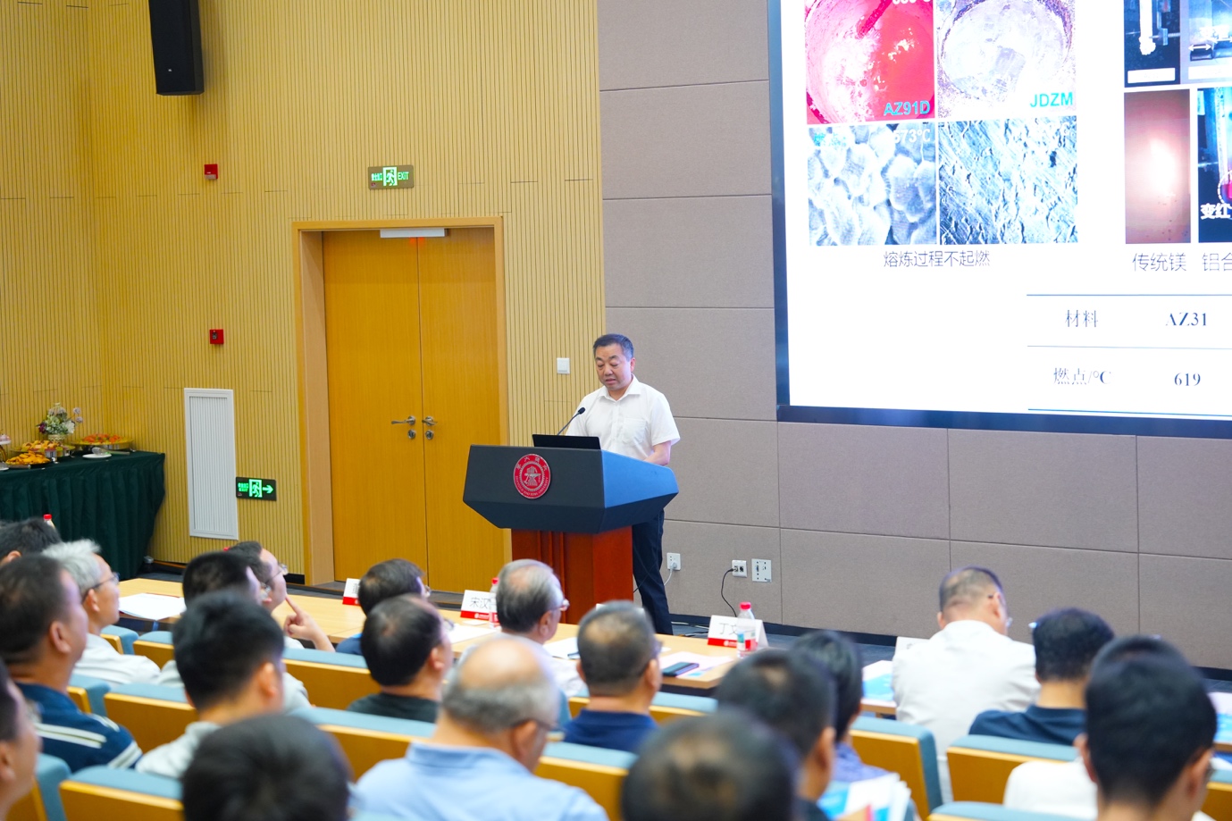 A person standing at a podium giving a presentation

Description automatically generated